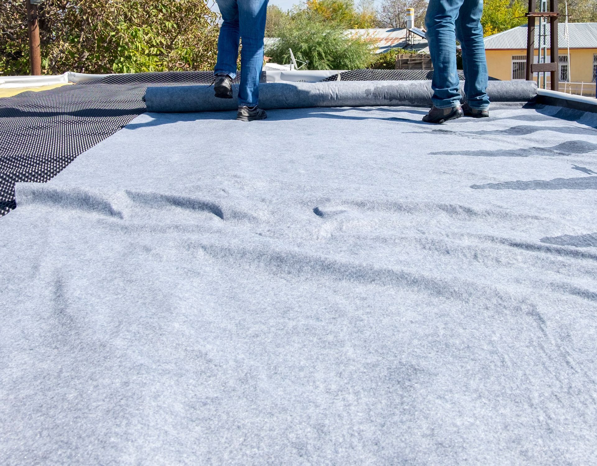A couple of people standing on top of a roof.