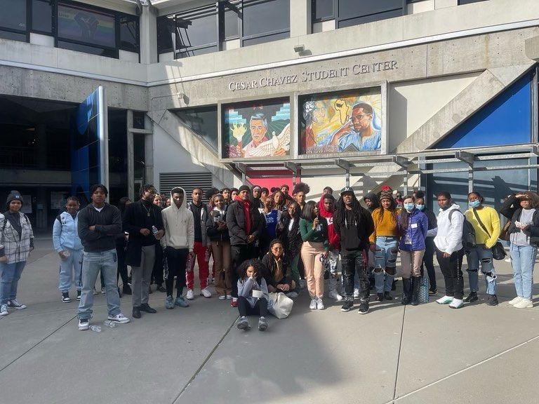 A group of people are standing in front of a building.