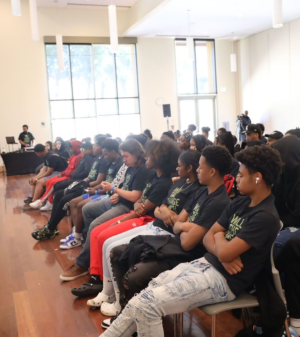 A group of people are sitting in a room with their arms crossed