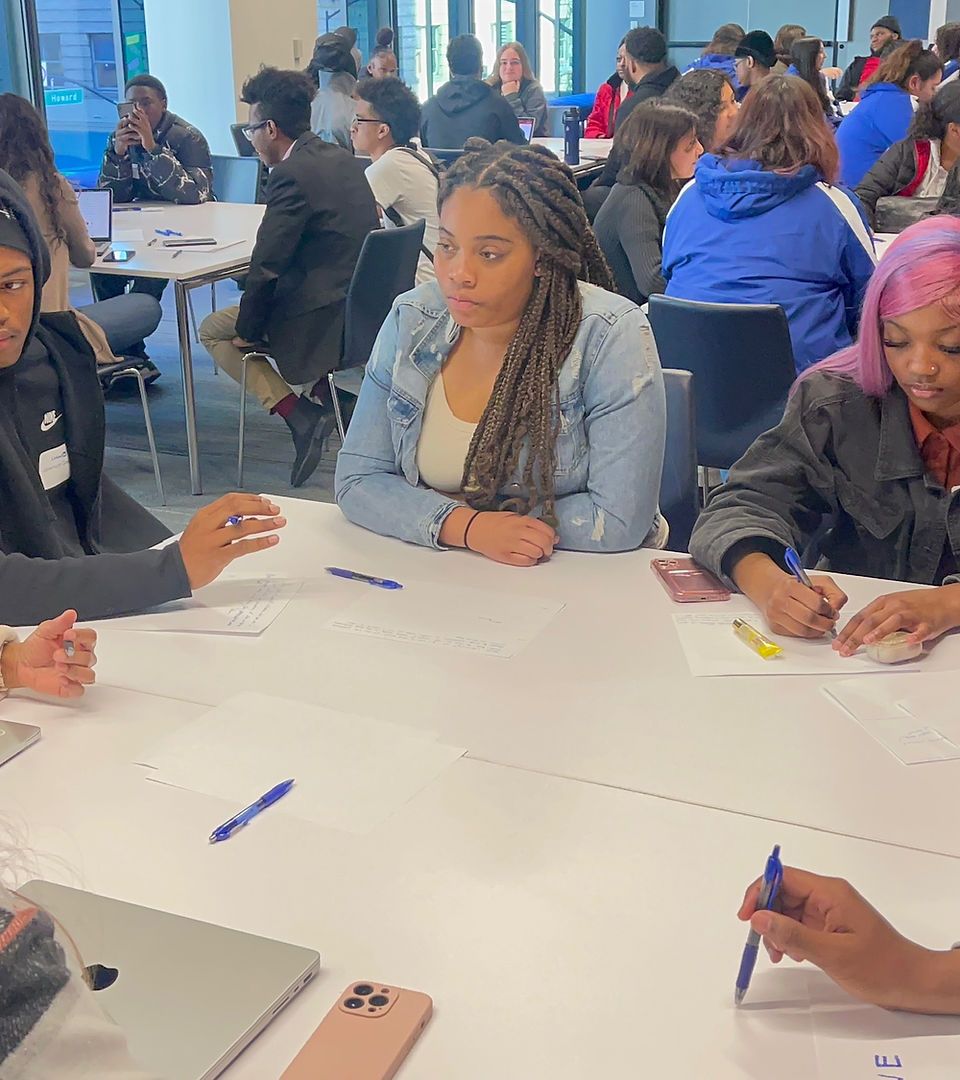 A group of people are sitting at tables in a room.