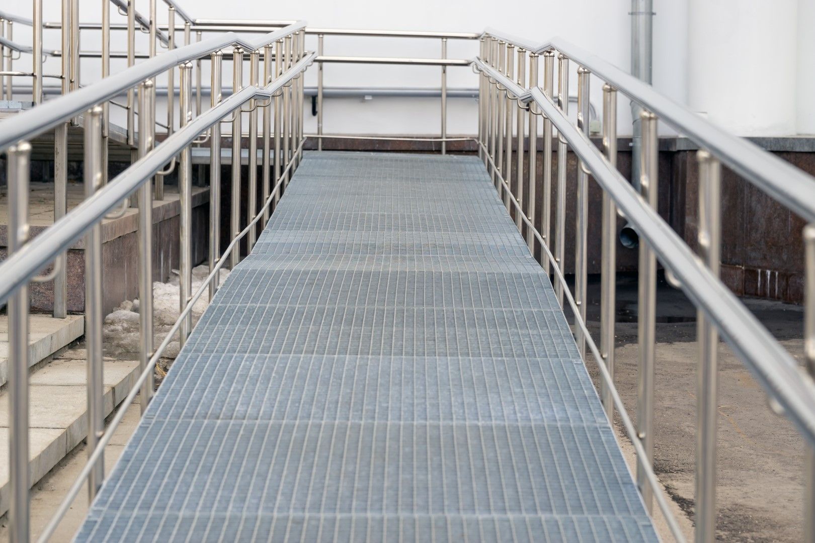 Safe metal stairway with supportive railing