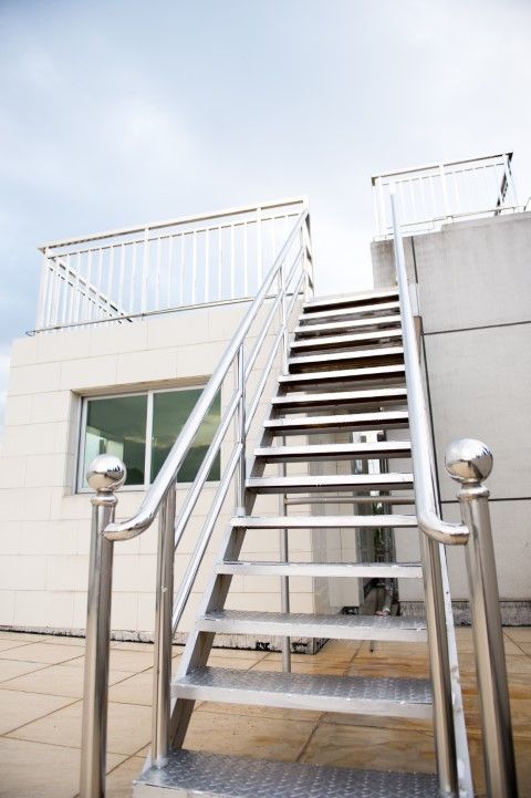 New metal staircase featuring a railing, blending utility and design