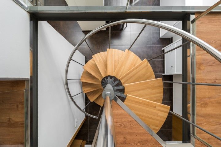 View from above of a stylish wooden and metal spiral staircase in Pinellas Park, FL