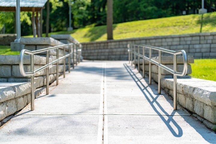 Exterior gray path featuring stairs and steel handrails
