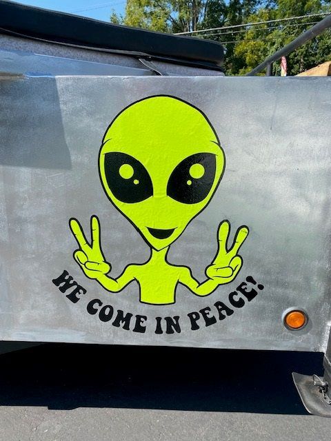 Neon green alien with peace signs, 