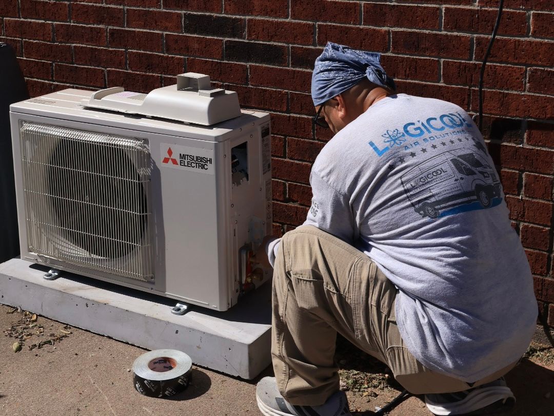 Logicool Air Solutions technician inspecting heat pump unit during tune-up in Corpus Christi, Texas.