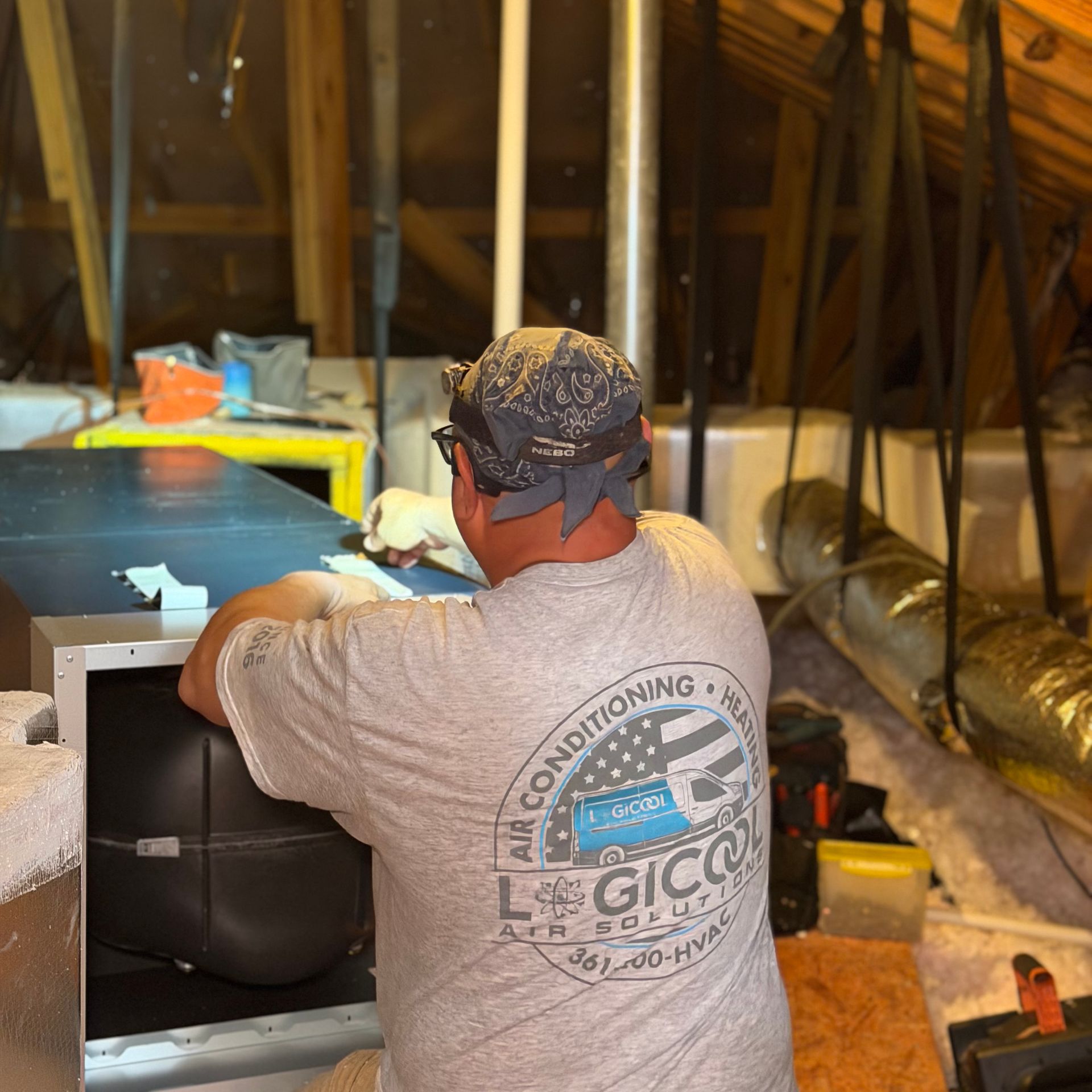 Logicool Air technician performing summer AC maintenance in a Corpus Christi home.