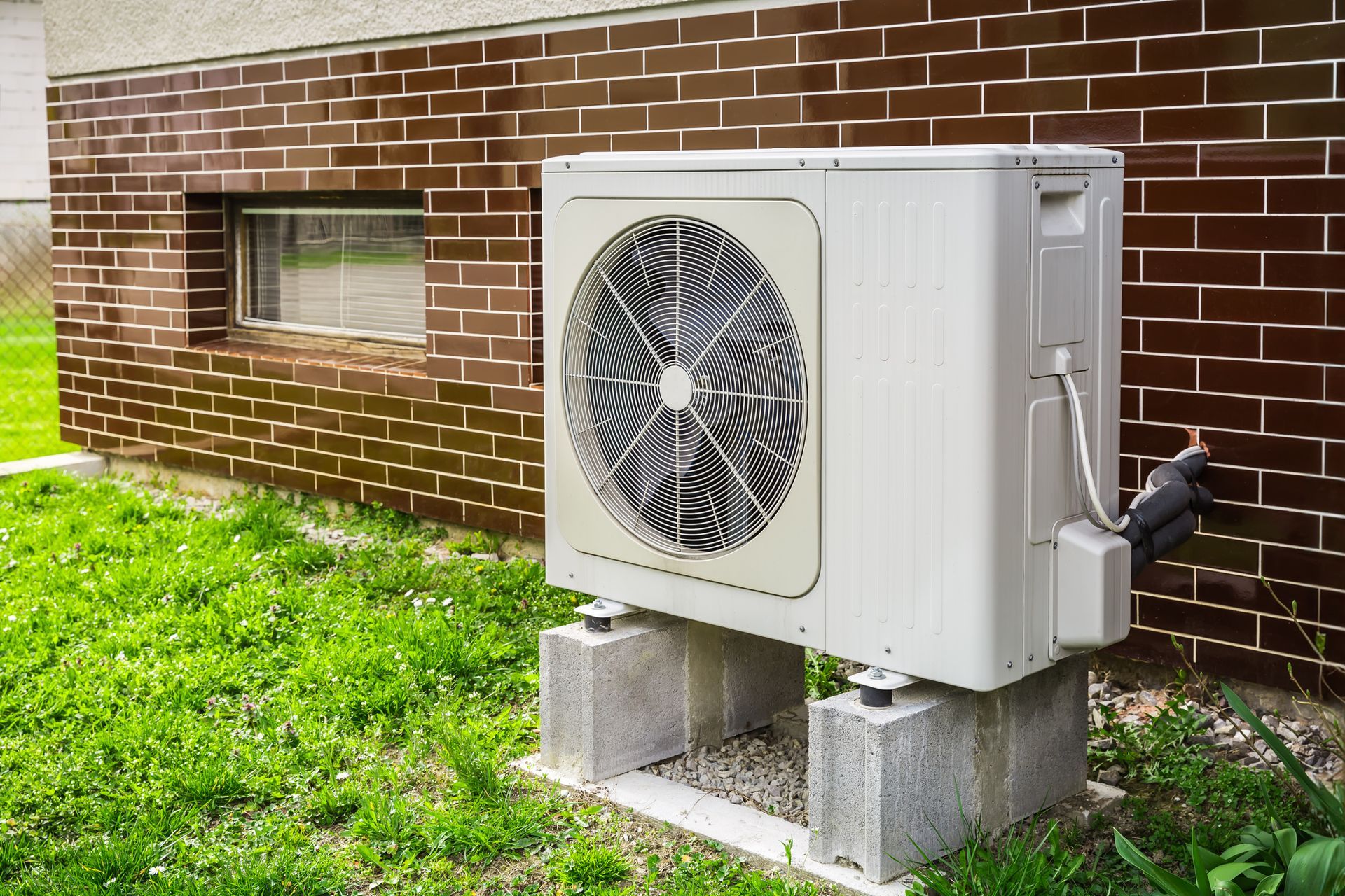 Logicool Air Solutions technician inspecting heat pump unit during tune-up in Corpus Christi, Texas.