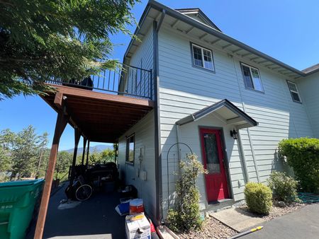 A two story house with new exterior paint and trim in Southern Oregon.