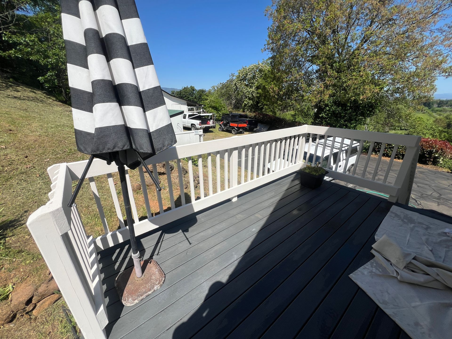 Professional deck staining and fence painting crew applying premium wood stain in Medford Oregon backyard