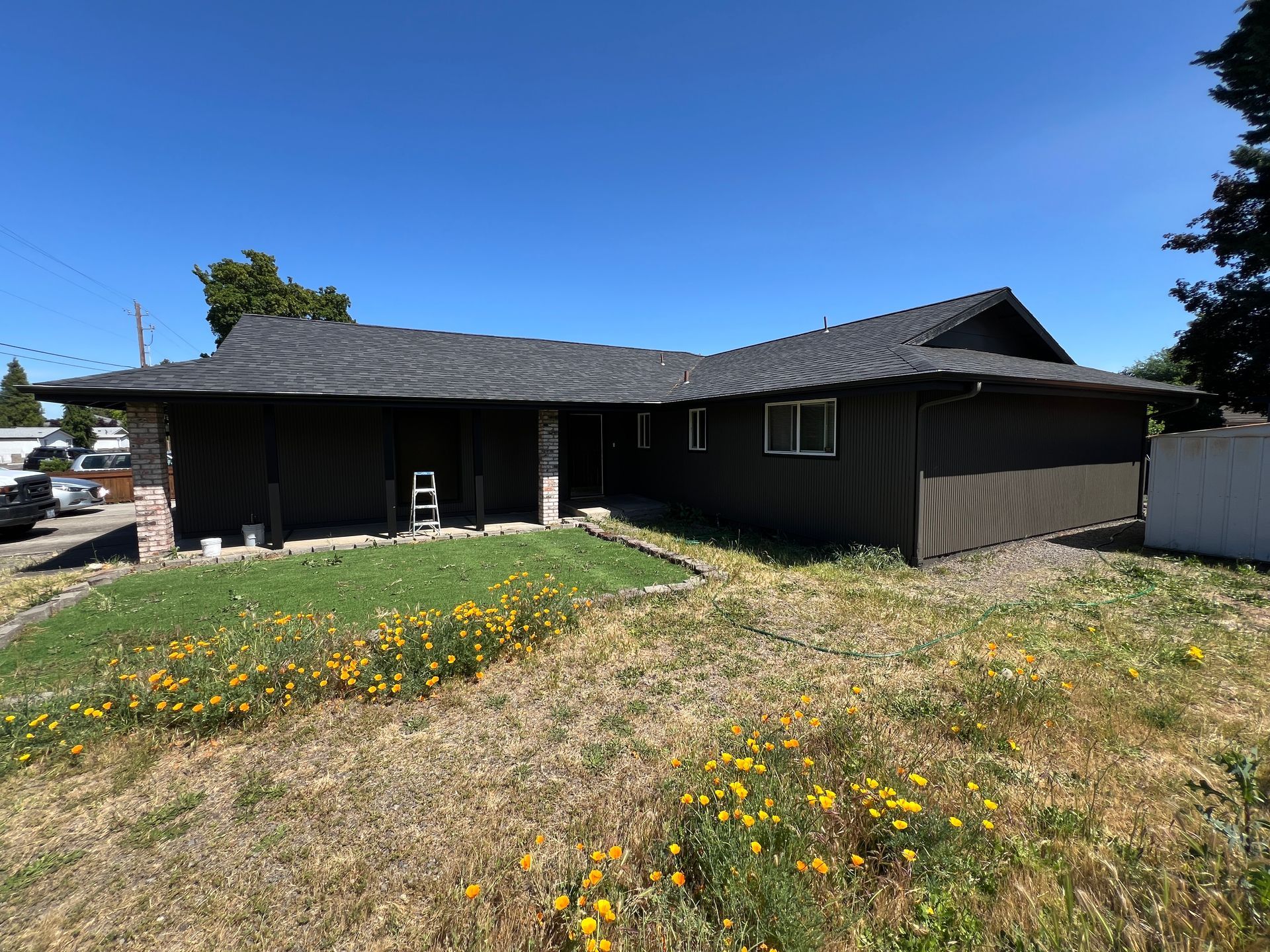 New exterior paint applied to  house in the summer by professional painters.