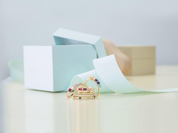 A stack of rings sitting on top of a table next to a box.