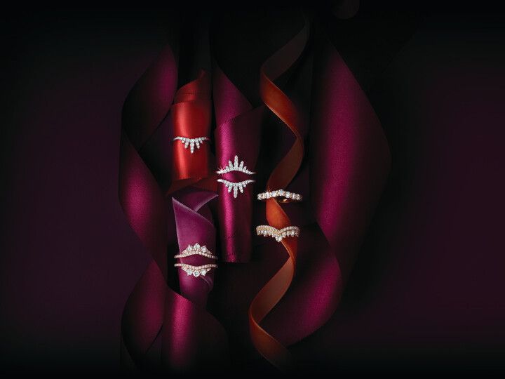 A group of rings are displayed on a purple cloth