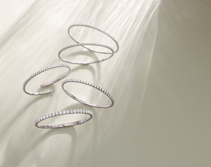 A group of rings are sitting on top of each other on a white surface.