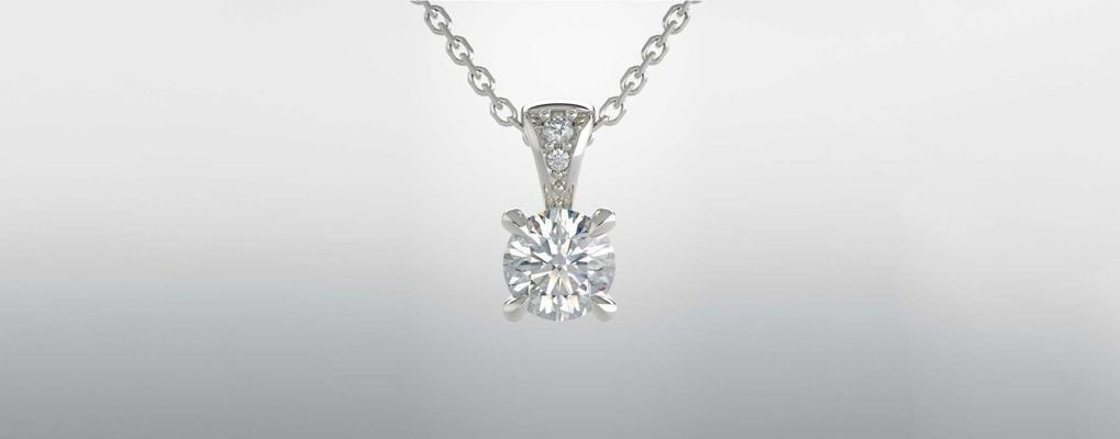 A close up of a diamond pendant on a chain.