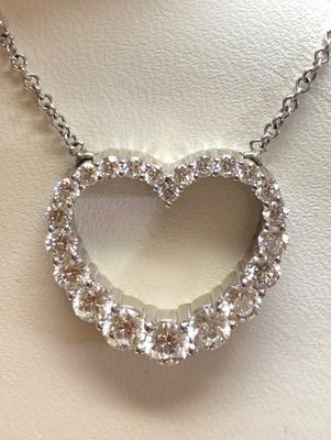 A necklace with a heart shaped pendant on a chain