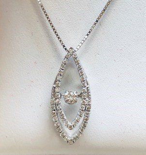 A close up of a necklace with a diamond pendant