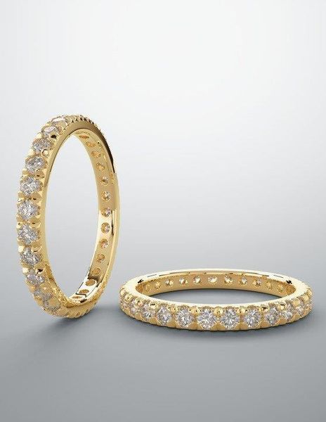 A pair of yellow gold rings with diamonds on them