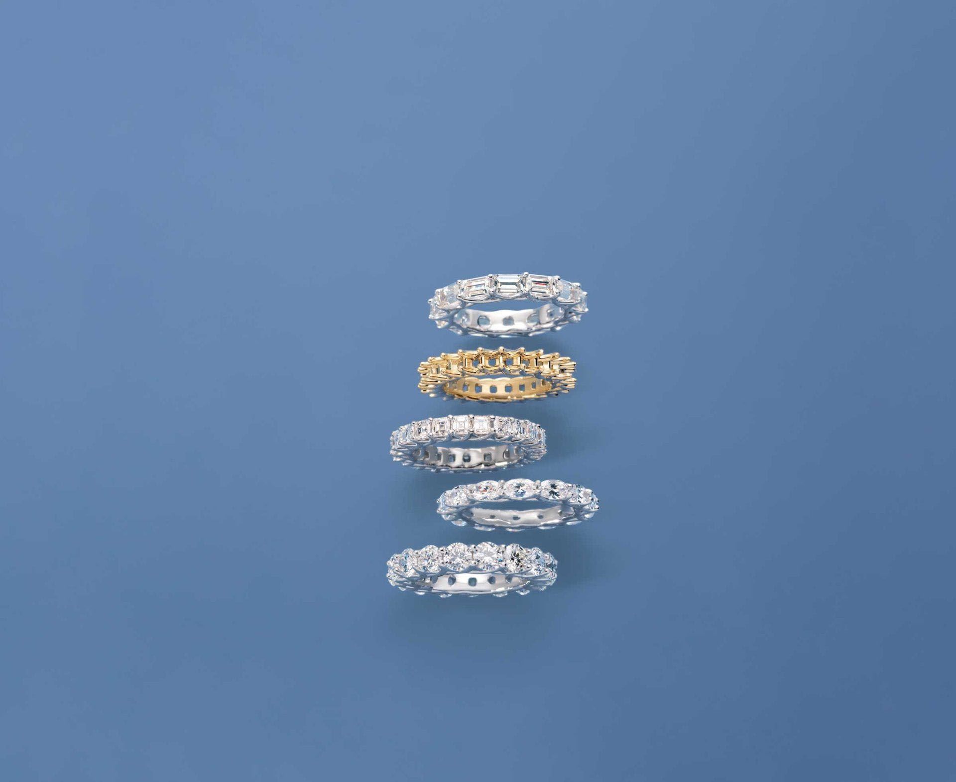 A row of rings stacked on top of each other on a blue surface.