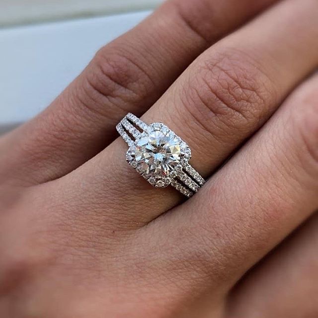 A woman wearing a wedding ring and engagement ring on her finger