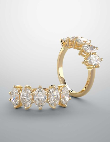 A gold ring with a row of diamonds on it