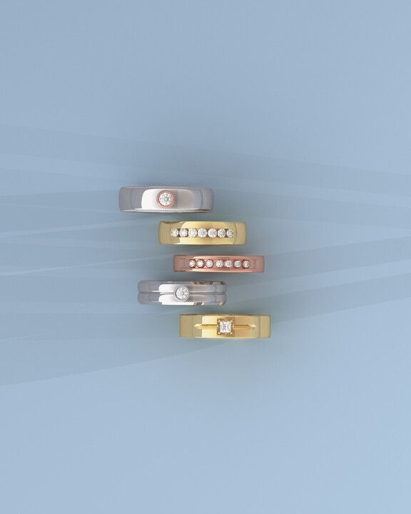 A group of rings are stacked on top of each other on a blue surface.