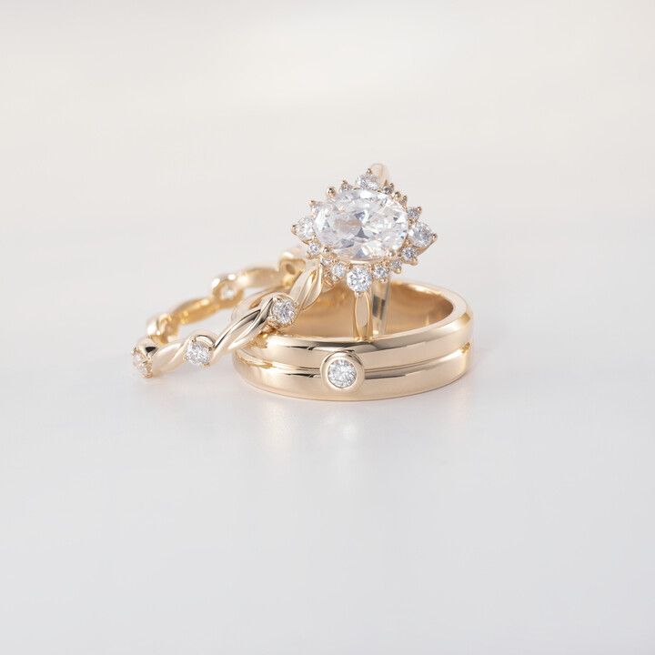 A couple of rings are stacked on top of each other on a white surface.