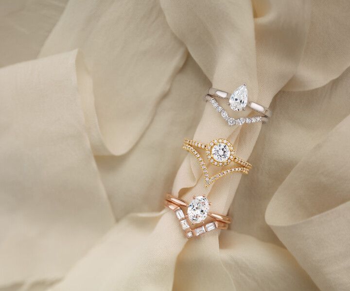 Three rings are stacked on top of each other on a white cloth.