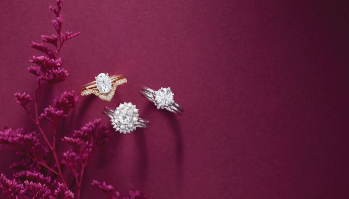 Three rings are sitting next to each other on a red background.