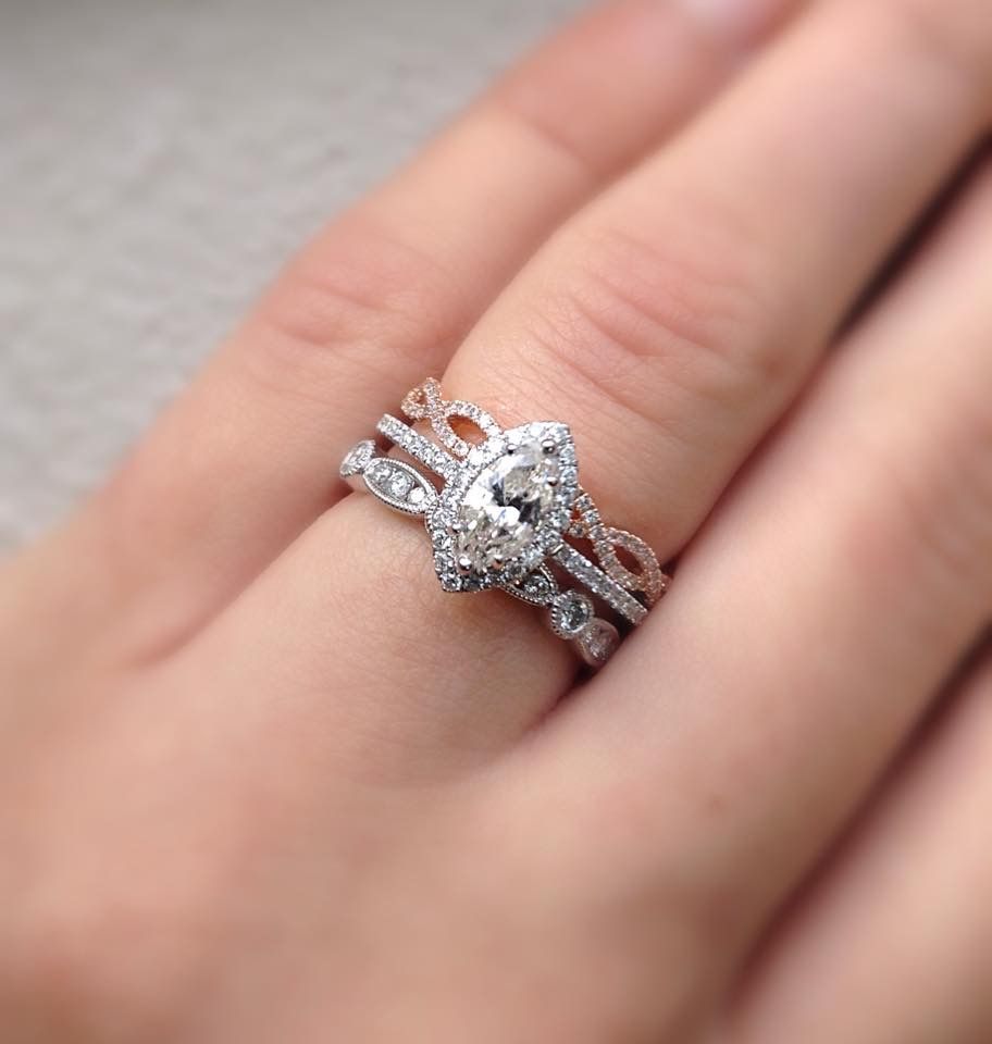 A woman wearing a wedding ring and engagement ring on her finger