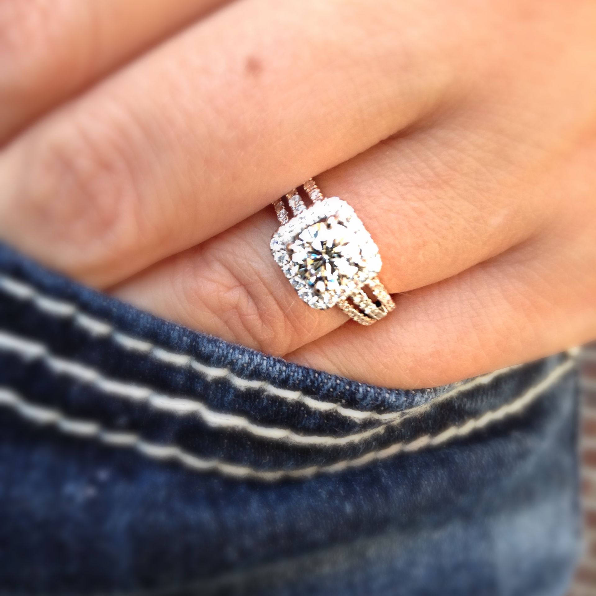 A woman wearing a wedding ring and engagement ring