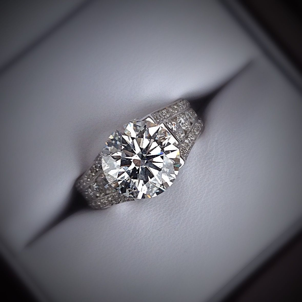 A diamond ring is sitting in a white box