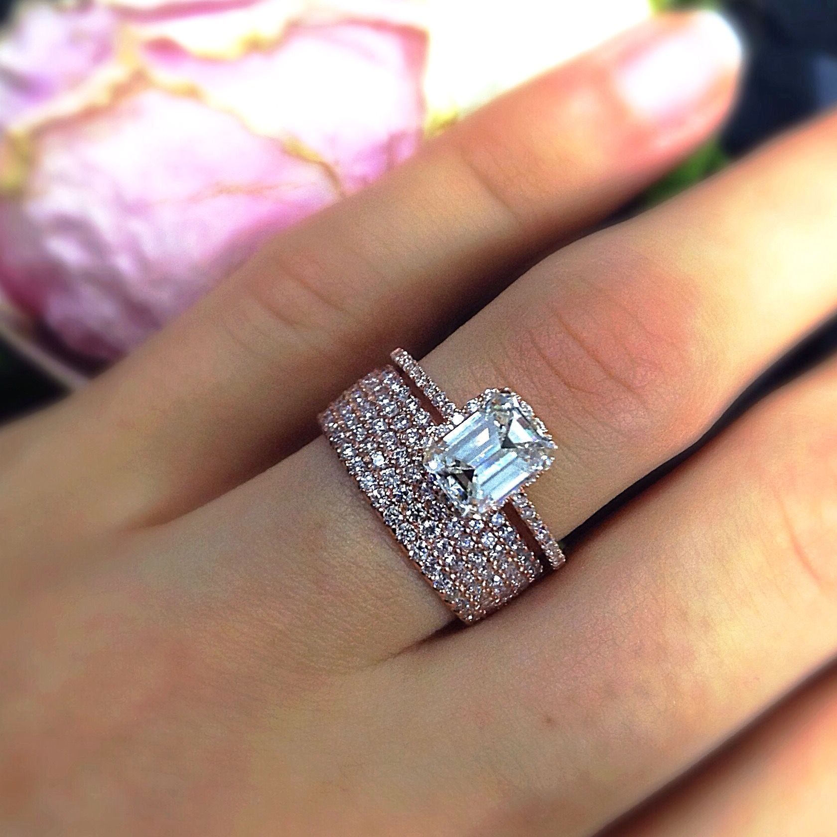 A woman wearing a wedding ring and engagement ring