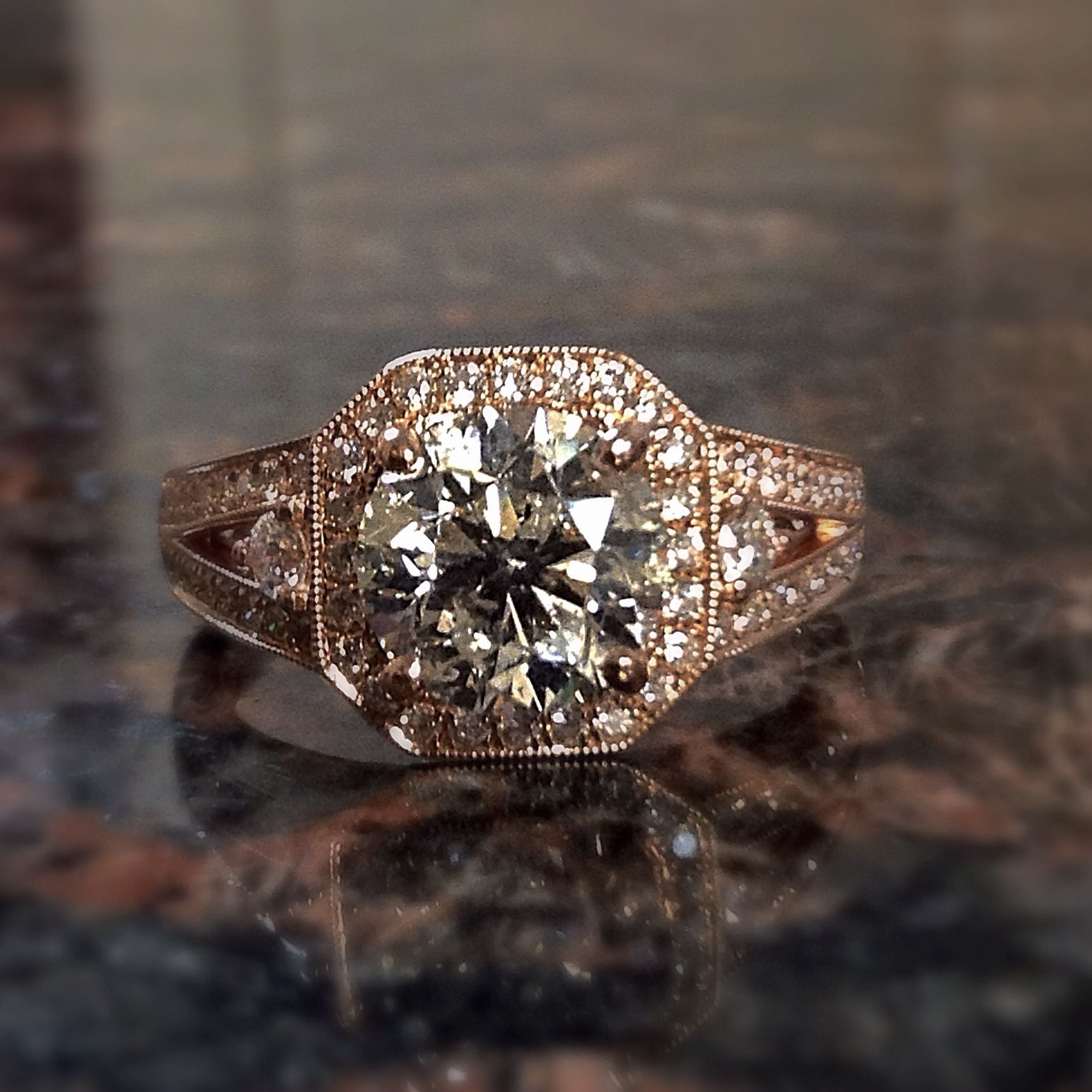 A close up of a diamond ring on a table