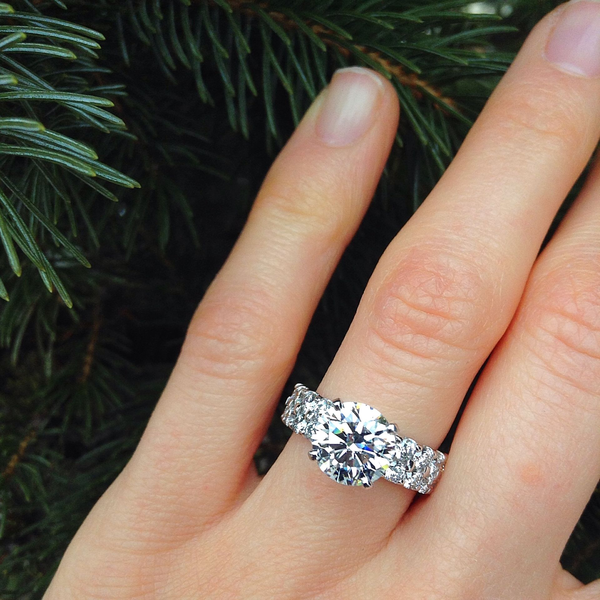 A woman wearing a diamond ring on her left hand