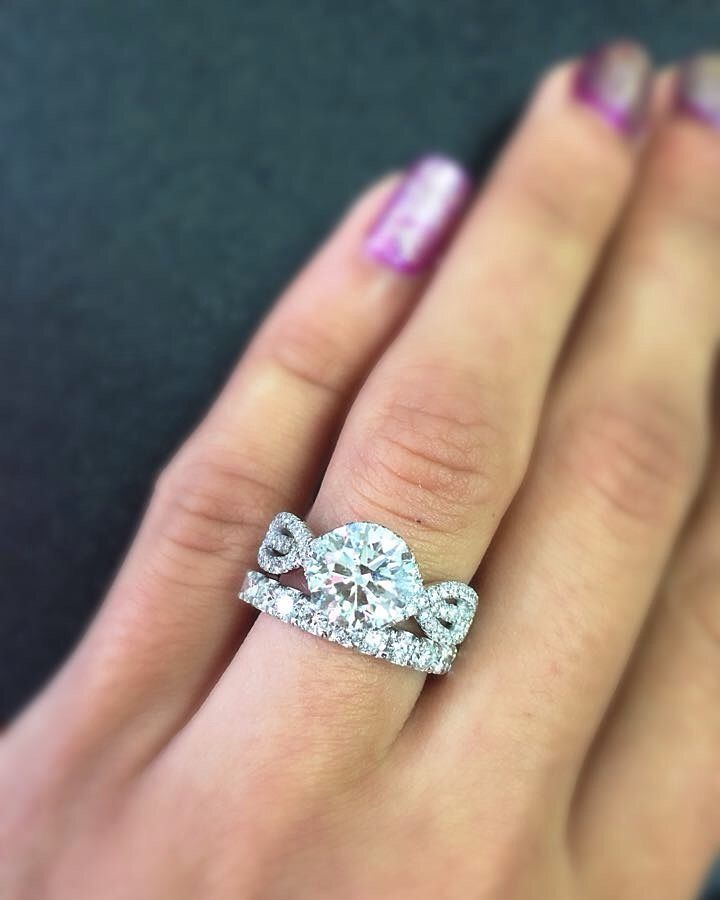 A woman wearing a wedding ring and engagement ring