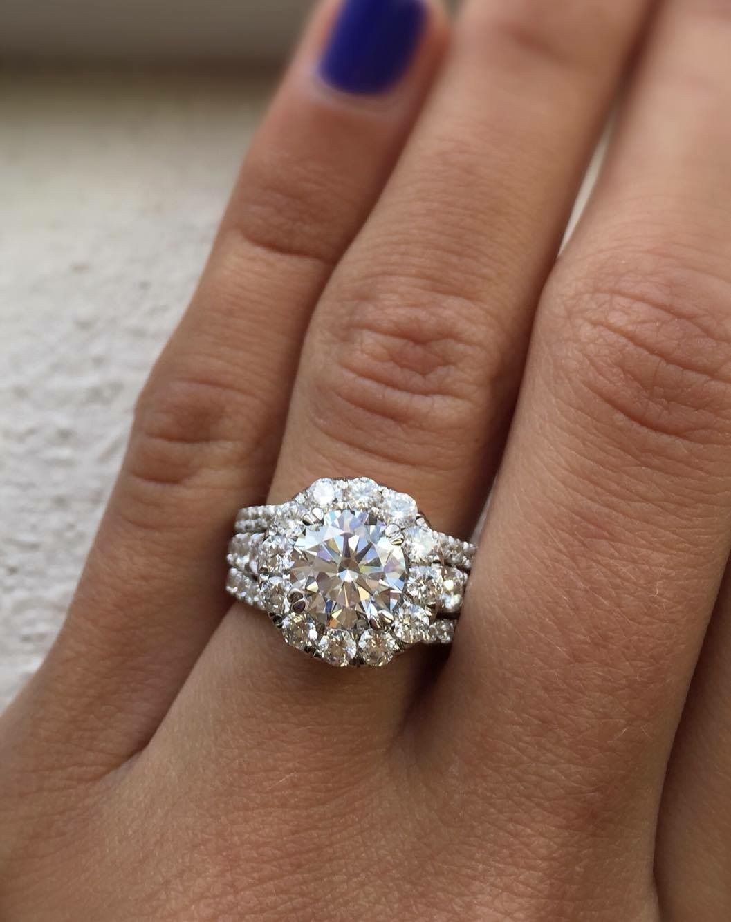 A woman 's hand with a diamond ring on it