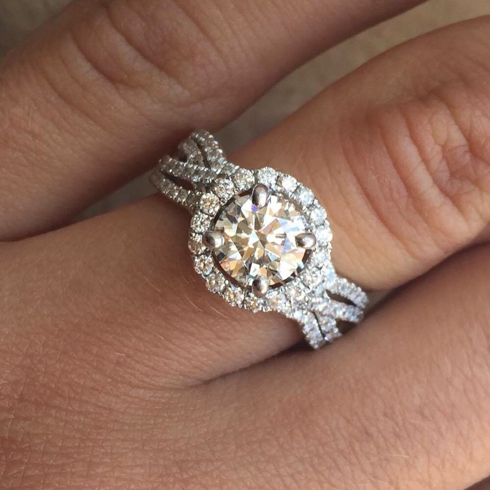 A woman is wearing a diamond ring on her left hand