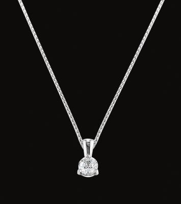A necklace with a diamond pendant on a chain on a black background.