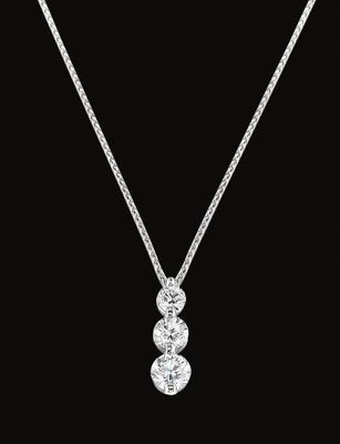 A necklace with three diamonds on a chain on a black background.