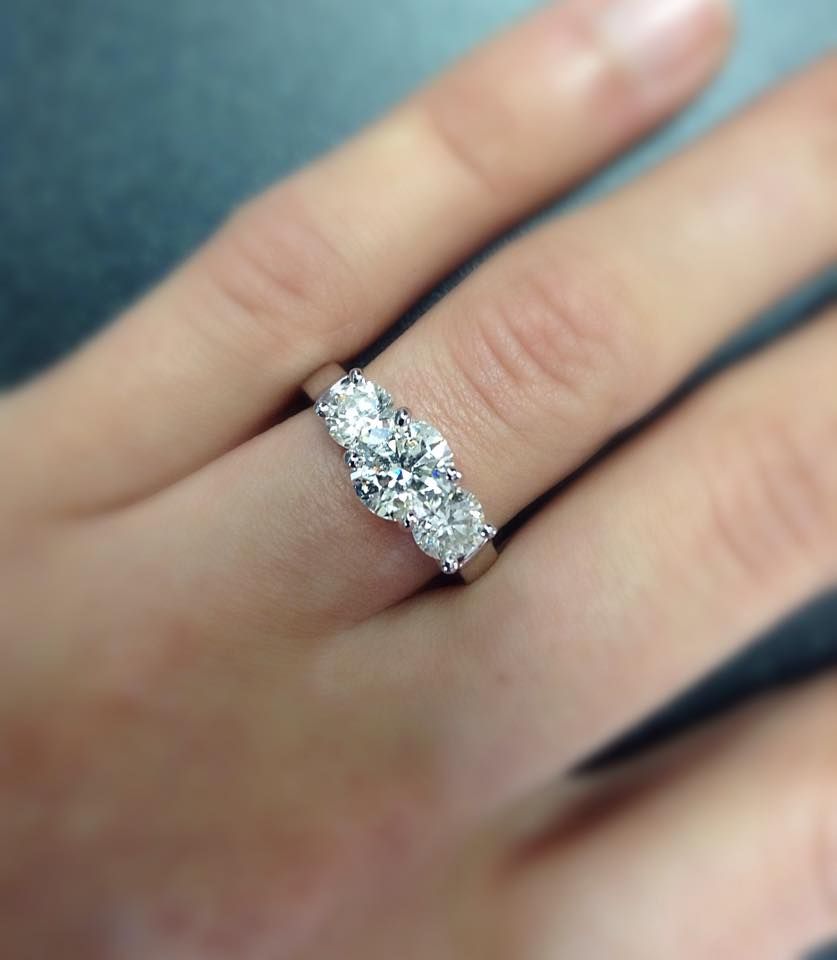 A woman is wearing a diamond ring on her left hand