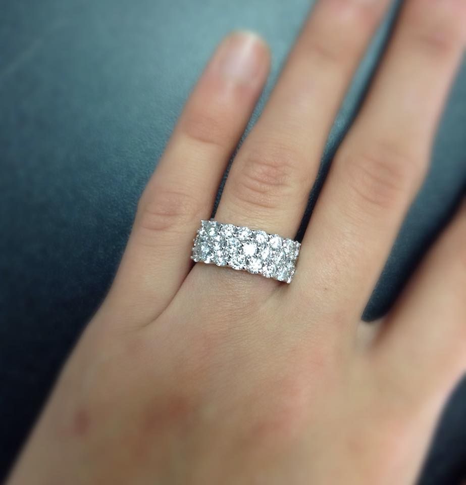 A woman wearing a diamond ring on her left hand