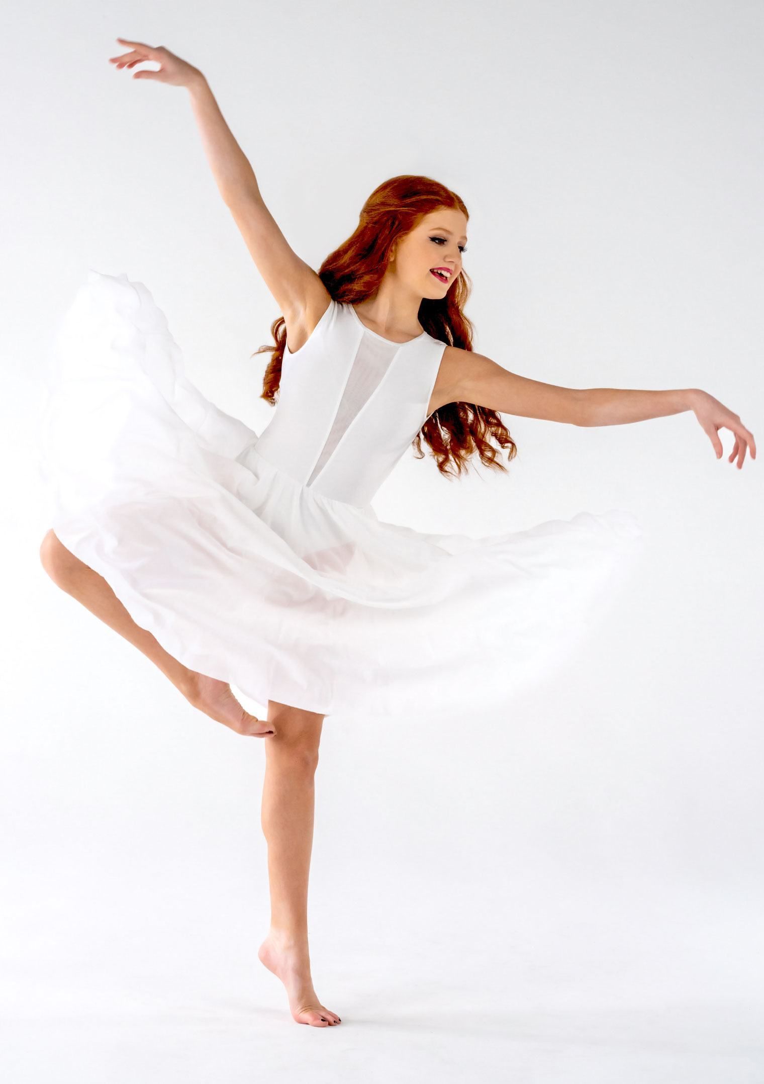 A Woman In A White Dress Is Dancing On One Leg — Dance Jam In Burnside, QLD