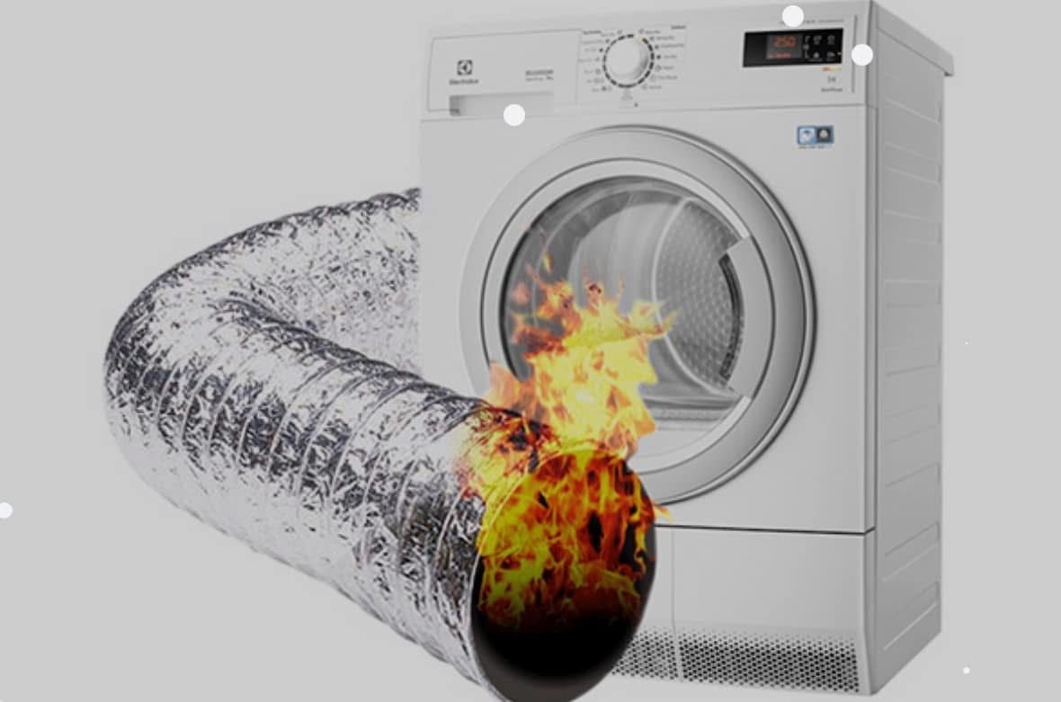 A washer and dryer with a fire coming out of it.