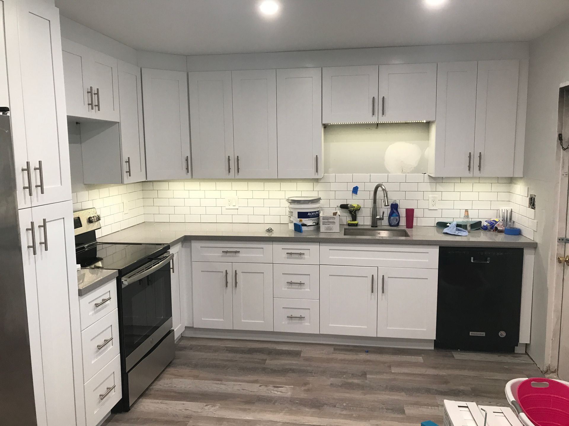 Kitchen electrical work and lighting installation during white cabinet remodel