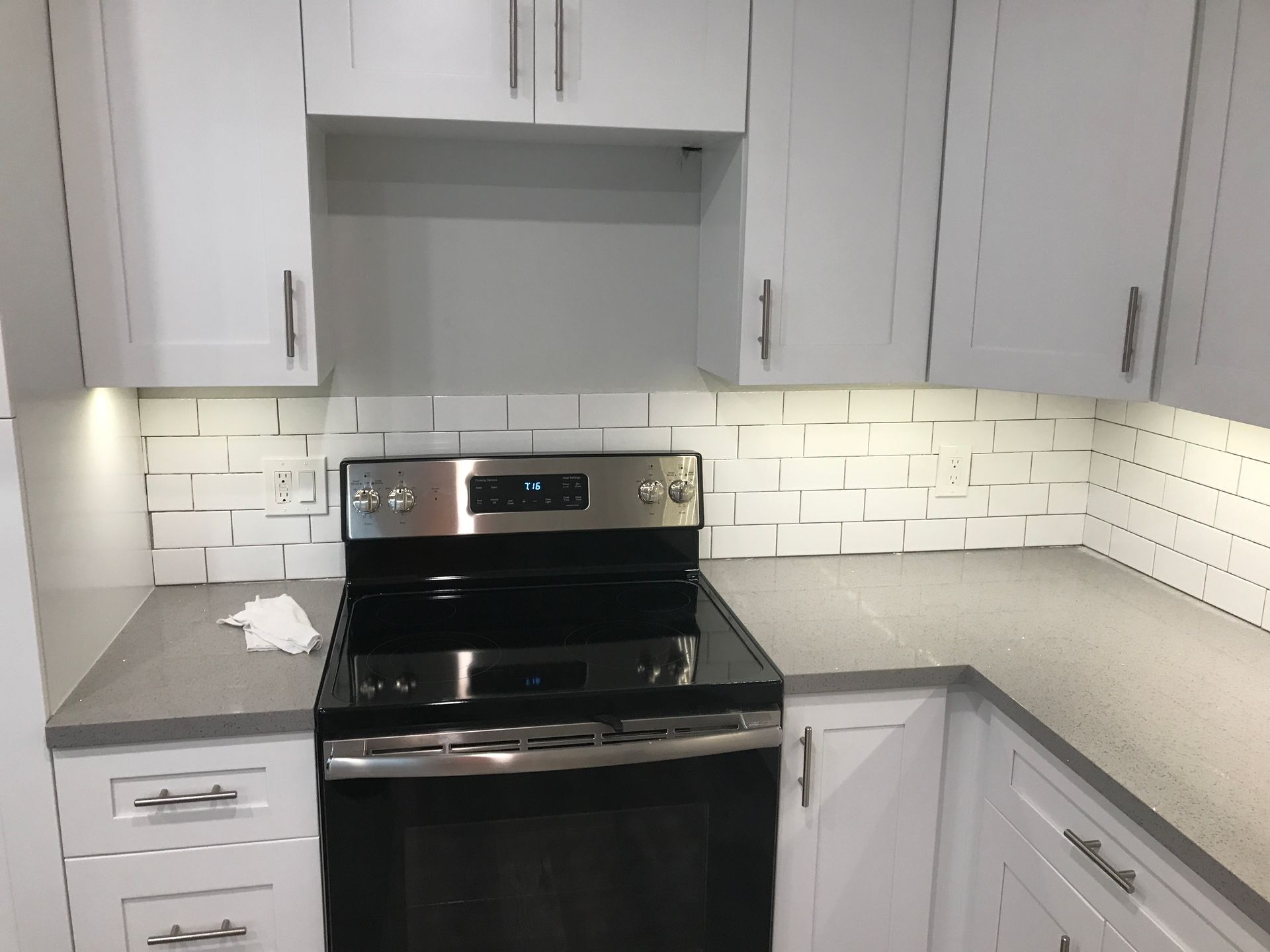 Under-cabinet lighting and outlet installation in modern kitchen electrical project