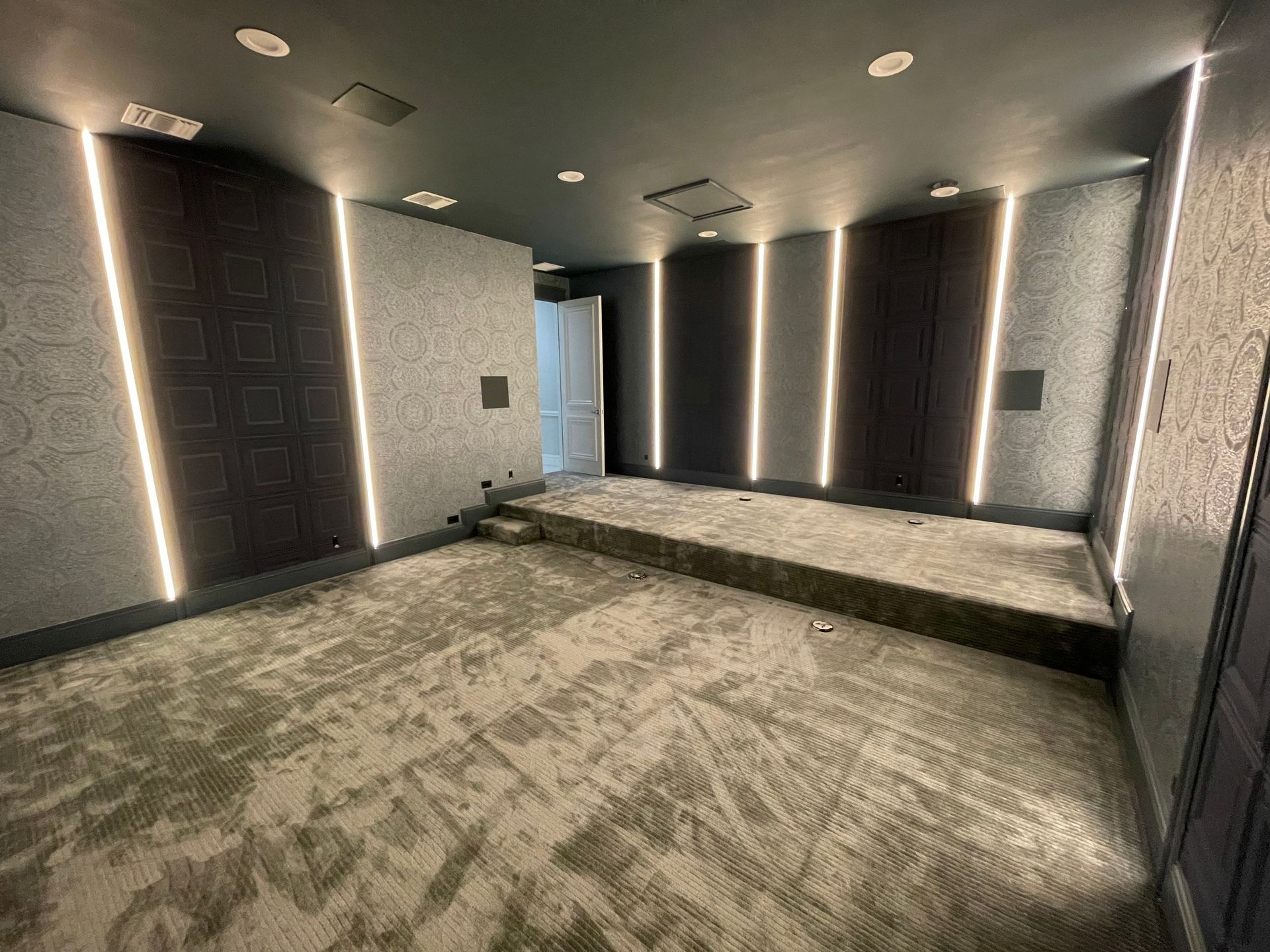 Custom home theater lighting installation with vertical LED accent panelsCustom home theater lighting installation with vertical LED accent panels