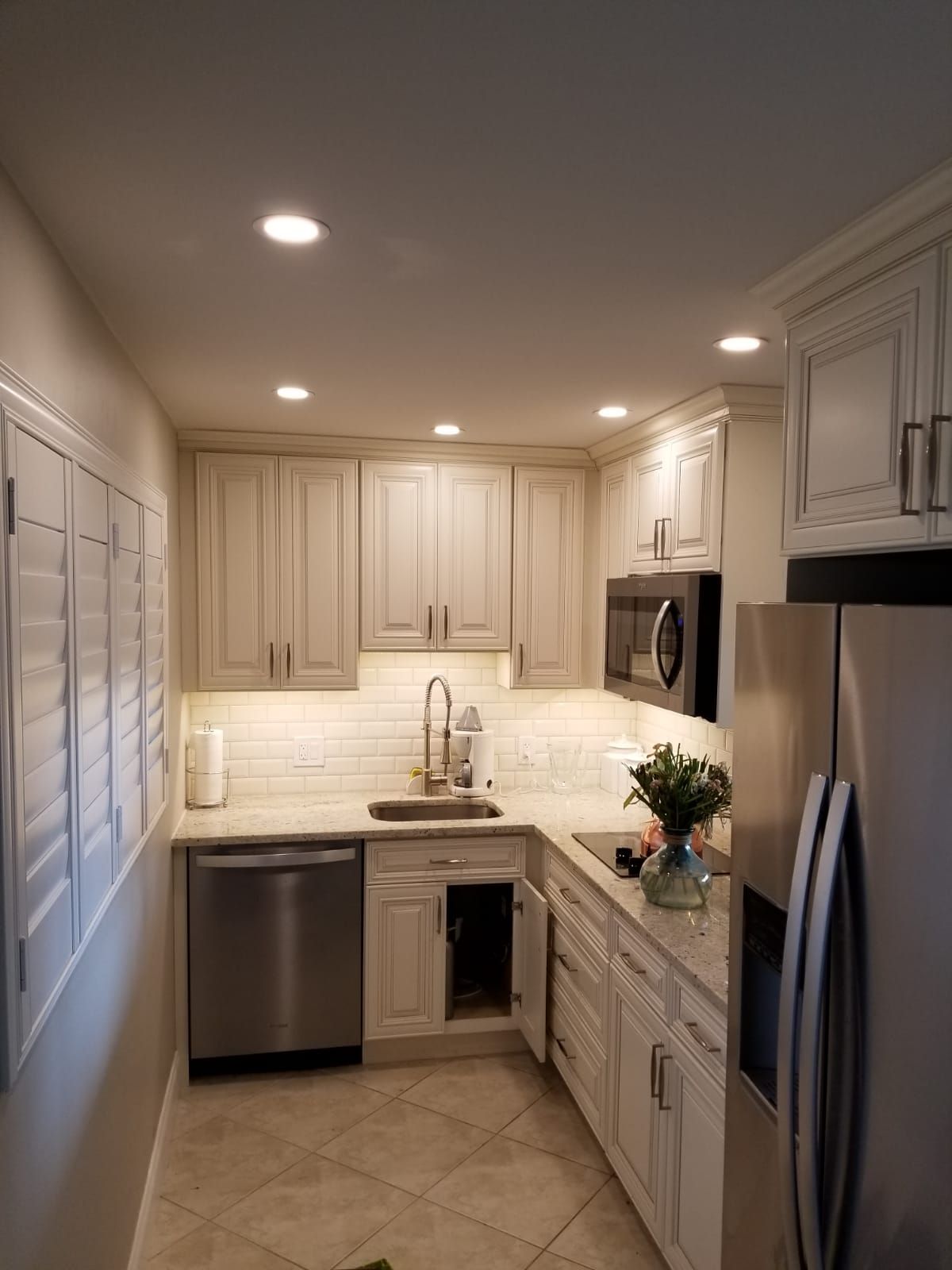 Electrical installation with recessed lighting and cabinet-mounted lights in traditional kitchen