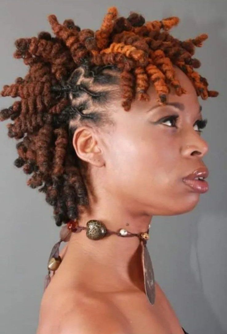 a woman with dreadlocks has a necklace around her neck