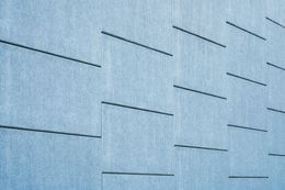 A close up of a blue wall with lines on it